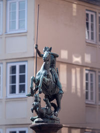 Low angle view of statue against building