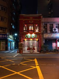 Illuminated city street at night