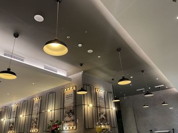 Low angle view of illuminated pendant lights in building