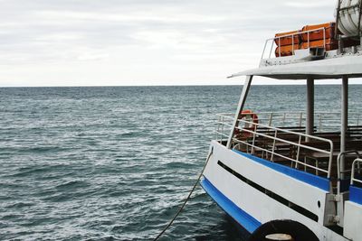 Boat sailing in sea against sky