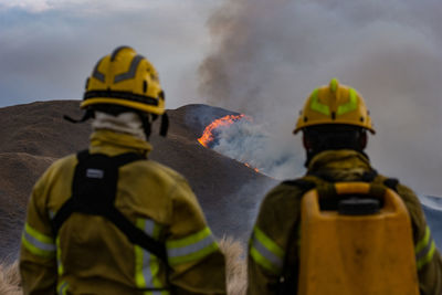 Rear view of two people looking away