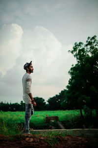 Full length of man standing on field against sky