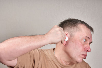 Close-up portrait of man against wall