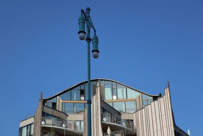 Low angle view of street light against clear blue sky