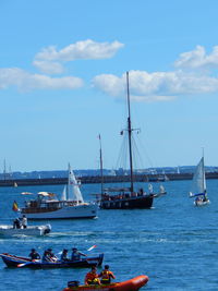 Boats sailing in sea against sky