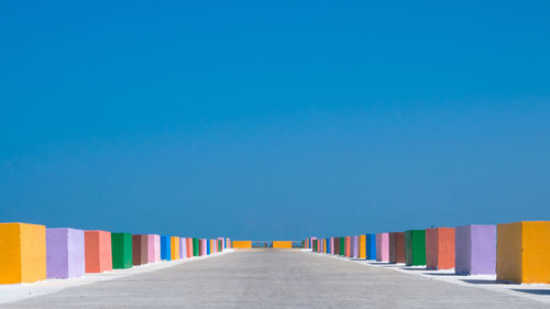 View of beach against clear blue sky