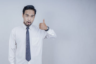 Mid adult man standing against white background