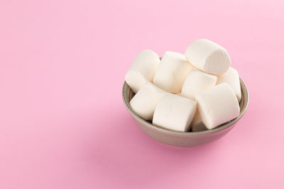 High angle view of food in container against pink background