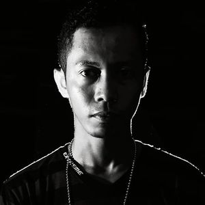 Close-up portrait of young man against black background