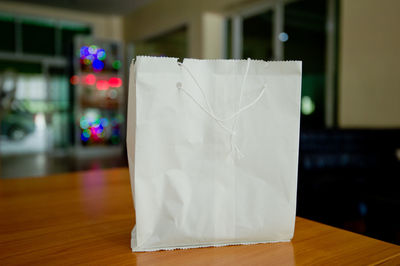 Close-up of paper hanging on table at home