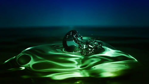 Close-up of water drop on blue surface