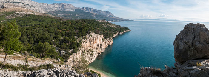 Panoramic view of sea and mountains against sky