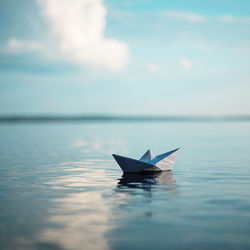 Paper boat floating on sea