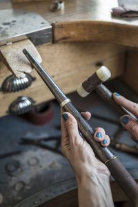 Cropped hands of woman working at workshop