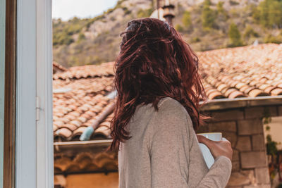 Rear view of woman looking at camera