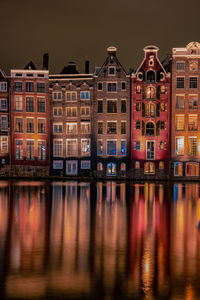 Reflection of buildings in canal at night