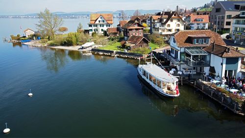 Boats in river with buildings in background