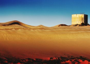 Scenic view of desert against clear sky