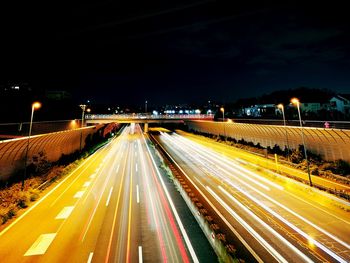 High angle view of light trails on road at night