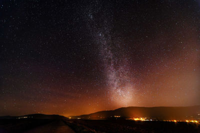 Scenic view of landscape against sky at night