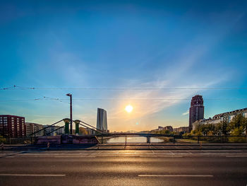 Bridge over city buildings against sky