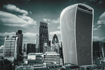 Low angle view of buildings against cloudy sky