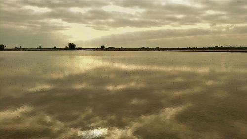 Scenic view of sea against cloudy sky