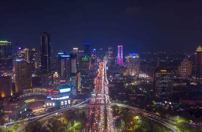 High angle view of illuminated buildings in city at night