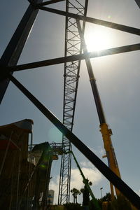 Low angle view of crane against sky