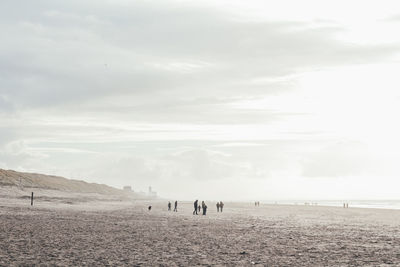 People on beach against sky