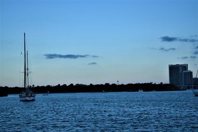 Sailboats in sea against sky