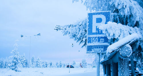 Snow covered landscape against blue sky