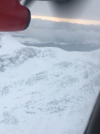 Aerial view of snowcapped mountains against sky