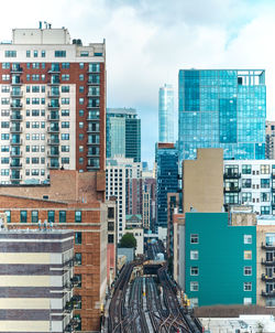 Modern buildings in city against sky