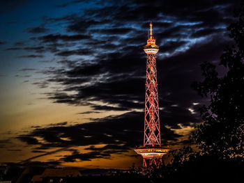 Low angle view of communications tower at night