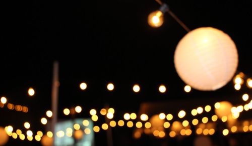 Illuminated city against sky at night