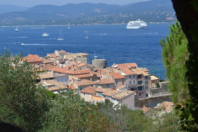 High angle view of sea by trees against sky