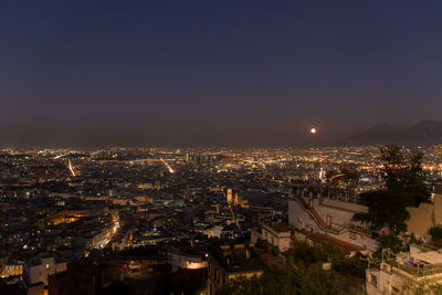 High angle view of illuminated buildings in city at night