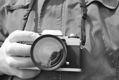 Close-up of man photographing camera