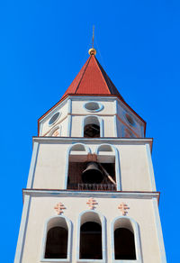 Bell tower with iron bell . steeple with red dome