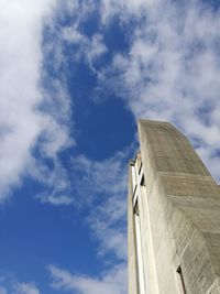 Low angle view of building against cloudy sky