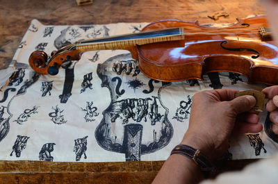 Violin makerviolin maker luthier changing bridge of a handmade baroque