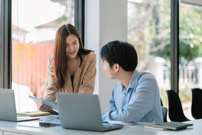 Businesswoman using laptop at office