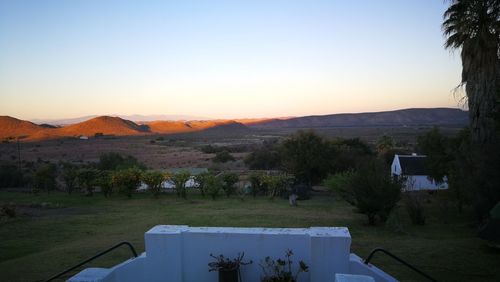 Scenic view of field against clear sky during sunset