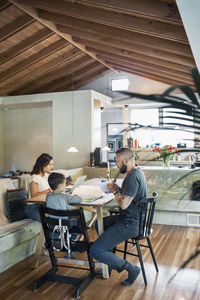 Family sitting at dining table in house