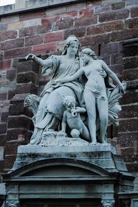 Low angle view of statue against wall