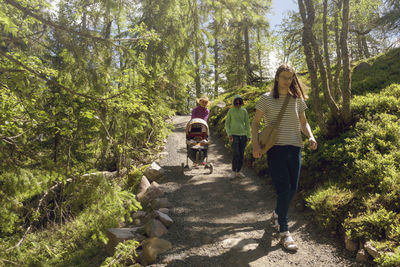 Family walking through forest