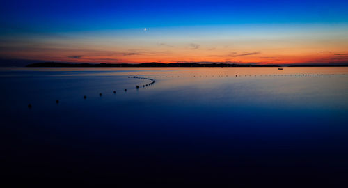 Scenic view of sea against sky at sunset