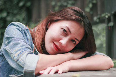 Portrait of smiling woman sitting outdoors