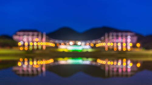 Defocused image of illuminated mae fah luang university against sky at dusk